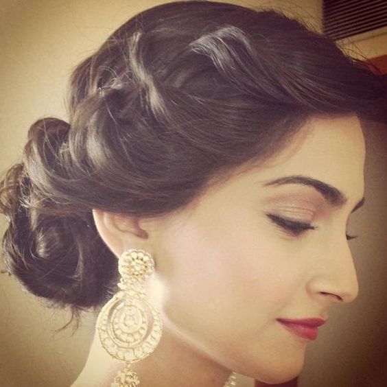 Indian wedding hairstyles for Indian Brides | Sonam Kapoor twisted side  style with curled bun - Witty Vows